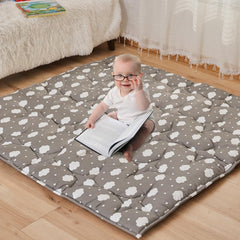 NapCure cloud-pattern play mat laid flat for safe baby playtime