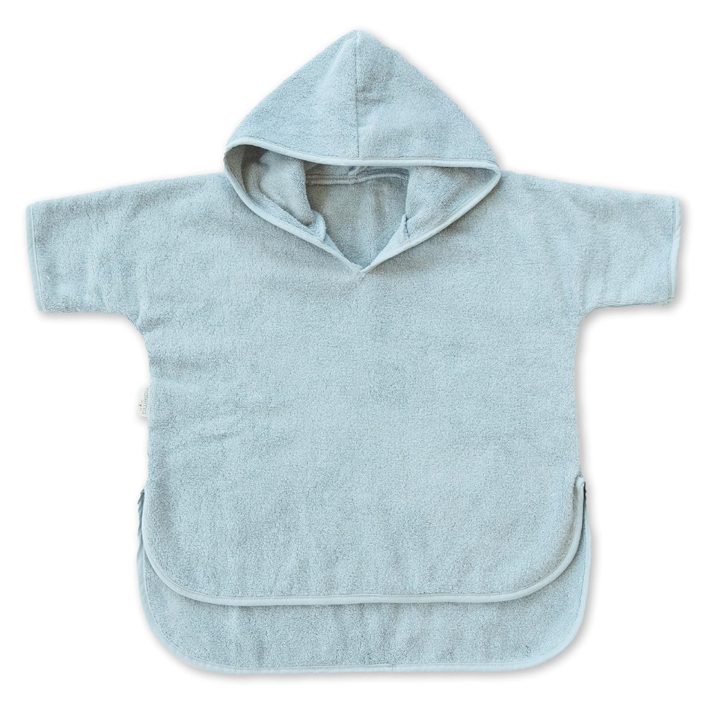 Natemia hooded towel poncho on the beach offers cozy warmth after swimming