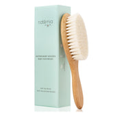 Natemia wooden baby hair brush with goat hair bristles delivering gentle scalp care.