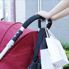 Newraturner diaper bag hanging from stroller with organized gear