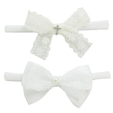Nihao Baby newborn bow cross closeup for baptism photo-ready look.