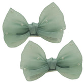 Nihao Baby Pearl Light Green Bow hair clip closeup highlighting glossy pearl accents for chic everyday hairstyles