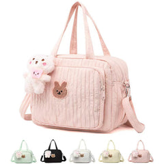 NIKUKY diaper bag tote fabric close-up highlights durable quilted nylon for daily use.