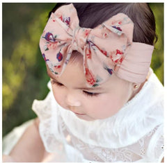 Nishine infant knot bow headwrap with a cute knot design for photos.