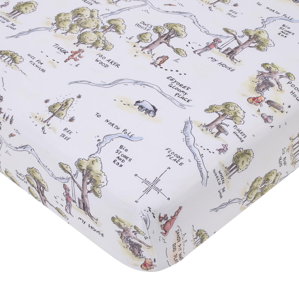 NoJo Disney Winnie the Pooh map crib sheet close-up shows 100 Acre Wood design for cozy nights