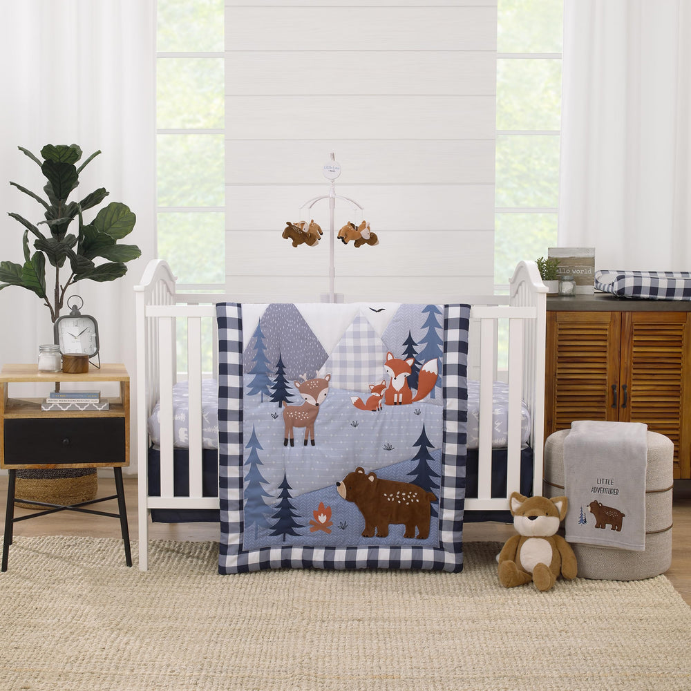 NoJo Little Love comforter featuring forest animals with navy buffalo check for a cozy nursery focal point