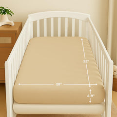 Nora's Nursery muslin crib sheets latte folded on baby bed for easy setup