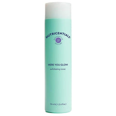 Nu Skin Here You Glow toner bottle demonstrates gentle exfoliation.