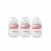Oberni glass baby bottle close-up shows anti-colic system for smoother feeds.