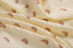 Onacosht muslin bassinet sheets rainbow close-up highlighting playful print