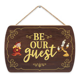 Open Road Brands Be Our Guest wall decor wood sign closeup highlighting classic typography on wood grain