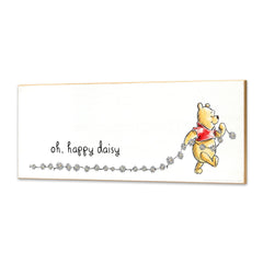 Open Road Brands Winnie the Pooh wall decor shows Pooh pulling daisies for playroom whimsy
