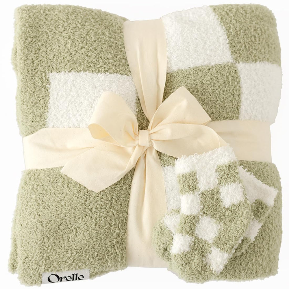 Orelle checkered baby blanket in sage green—soft fabric for cozy crib time.
