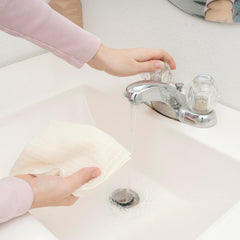 Organic Cotton Mart wipes being machine washed illustrates easy care routine.