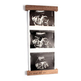 Oscar Bee sonogram frame in walnut finish highlights ultrasound keepsake for nursery decor.