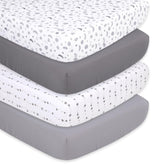 The Peanutshell crib sheet set showcases celestial planets on a crisp white background for peaceful naps.