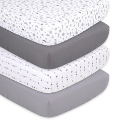 The Peanutshell crib sheet set showcases celestial planets on a crisp white background for peaceful naps.