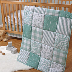 The Peanutshell forest-theme crib quilt adds cozy woodland detail for baby’s nursery.