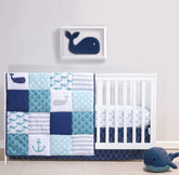 The Peanutshell nautical crib quilt shows anchors design for cozy, decorative nursery moments.