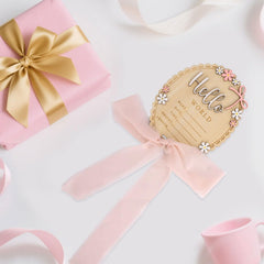 Penitue baby announcement sign pink ribbon detail showing rustic charm.