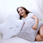 Perfectto Design white star pillow adds a playful focal point to a child's bed.