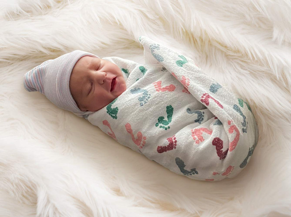 PILL THING baby-foot-prints-blanket offers soft, cozy swaddling for newborn comfort.