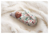 PILL THING baby swaddle blanket with footprint design for calm swaddling.