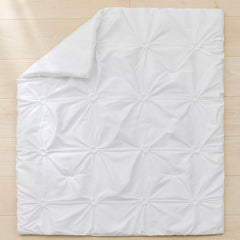 PINNKKU 14-inch drop crib skirt demonstrates full coverage and hidden storage space.