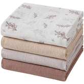 POMISO muslin swaddle blanket leaves pattern, ideal for swaddling and nursery decor.