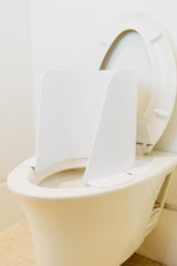 Potty Protector toilet shield protects against urine spray and bathroom splashes.
