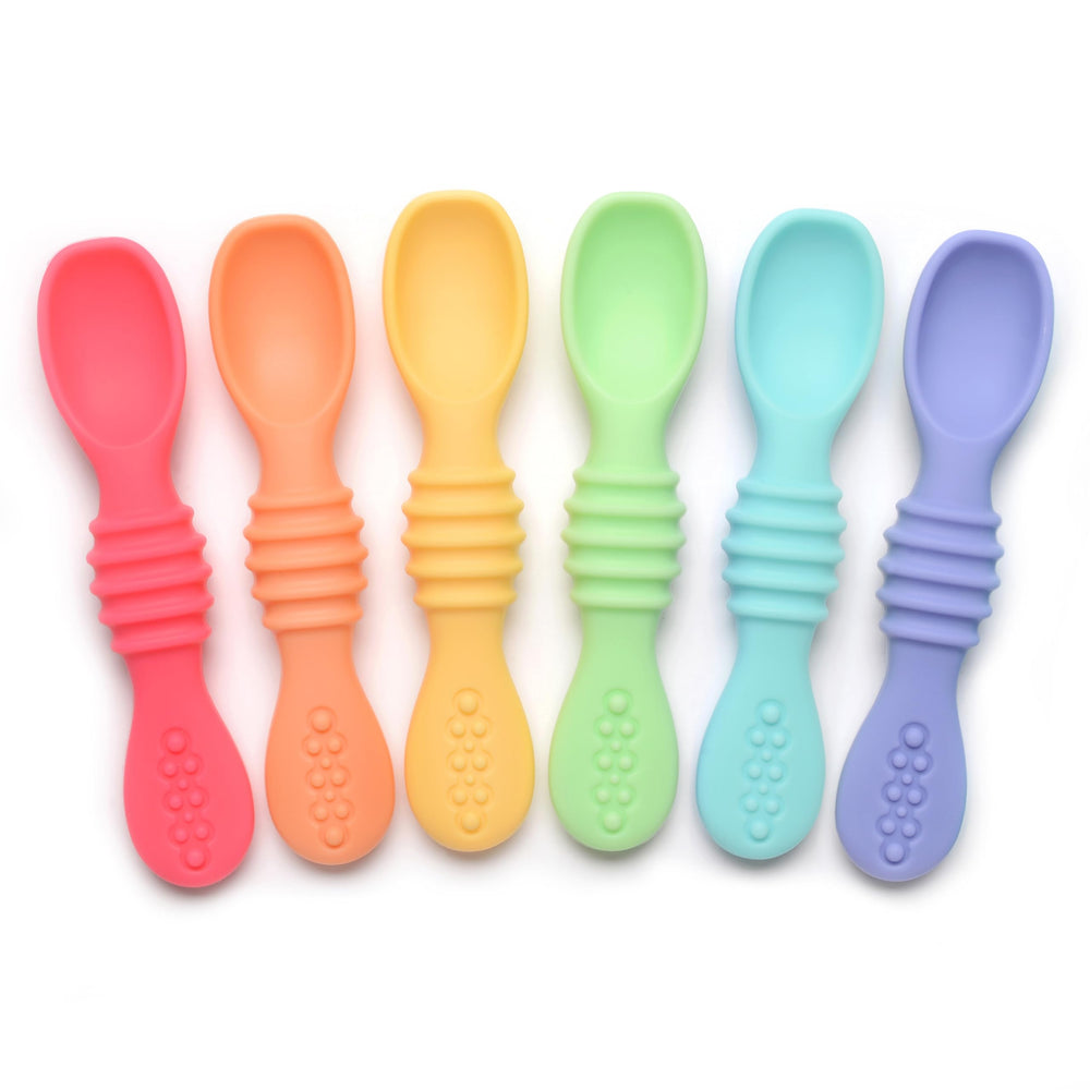 PrimaStella Summer Rainbow chew spoon in use, helping baby practice self-feeding with a safe grip.