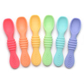 PrimaStella Summer Rainbow chew spoon in use, helping baby practice self-feeding with a safe grip.