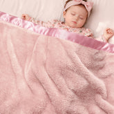 Pro Goleem pink satin-trim fleece baby blanket adds elegant warmth for cuddles.