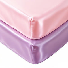 Pro Goleem Satin Soft Crib Sheet pink close-up shows silky texture for gentle hair care.