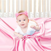 Pro Goleem satin soft pink crib sheet on mattress for gentle baby hair comfort.