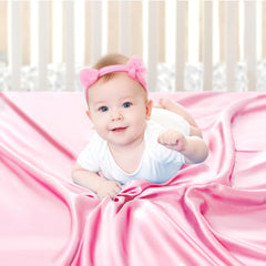 Pro Goleem satin soft pink crib sheet on mattress for gentle baby hair comfort.