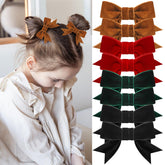 ProSuites red velvet hair bow ready to elevate festive outfits.