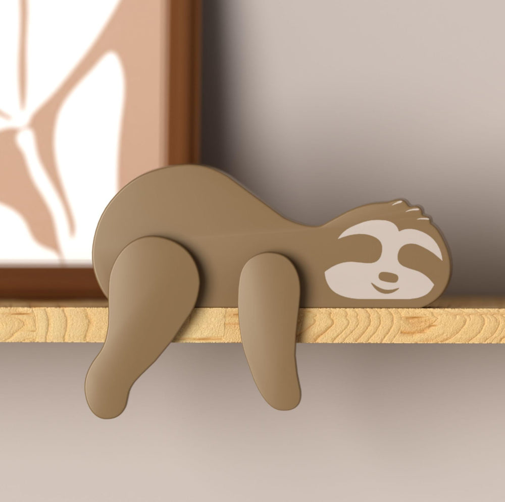 PUTSKA woodland sloth nursery decor on a shelf adds cozy forest charm