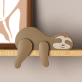 PUTSKA woodland sloth nursery decor on a shelf adds cozy forest charm