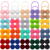 Qearl pom pom velvet hair ties closeup showing soft fluffy texture for kids.
