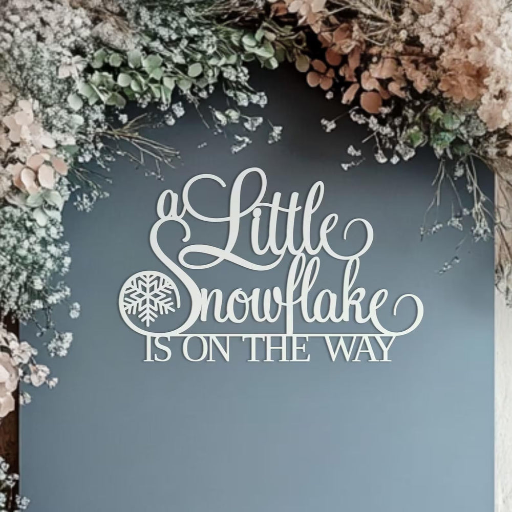 QPARTYFIRE A Little Snowflake Is On The Way sign backdrop for festive photos and winter parties.