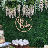 QPARTYFIRE Oh Baby sign backdrop mounted on wall for elegant baby shower decor.