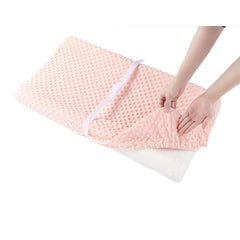 QUENESS coral-pink cover highlights ultra-soft comfort during diaper changes.