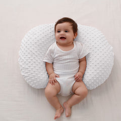 QUENESS BABY nursing pillow side view shows ergonomic support for bottle feeding.