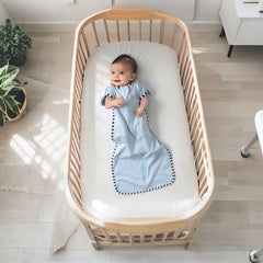 Queness Transition Swaddle baby sleeping—cozy cotton wrap supports calm rest.