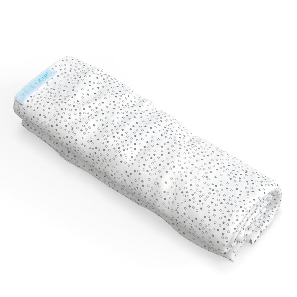 QuickZip crib extra zip-on sheet in gray dot on mattress enables quick, calm sheet changes.