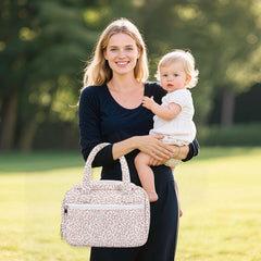 Rain Bunny wearable pump bag floral pink with multiple compartments for travel gear.