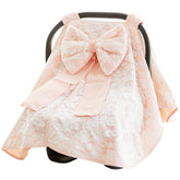 Razee baby carseat canopy cover bow closeup shows soft cotton, privacy, and gentle shade.