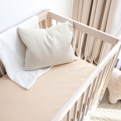 ROMY RO crib sheet in wheat with secure elastic edge for snug mattress cover.