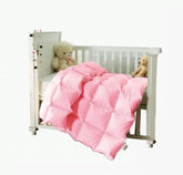 Rose Feather toddler-down blanket on crib showing breathable warmth for naps